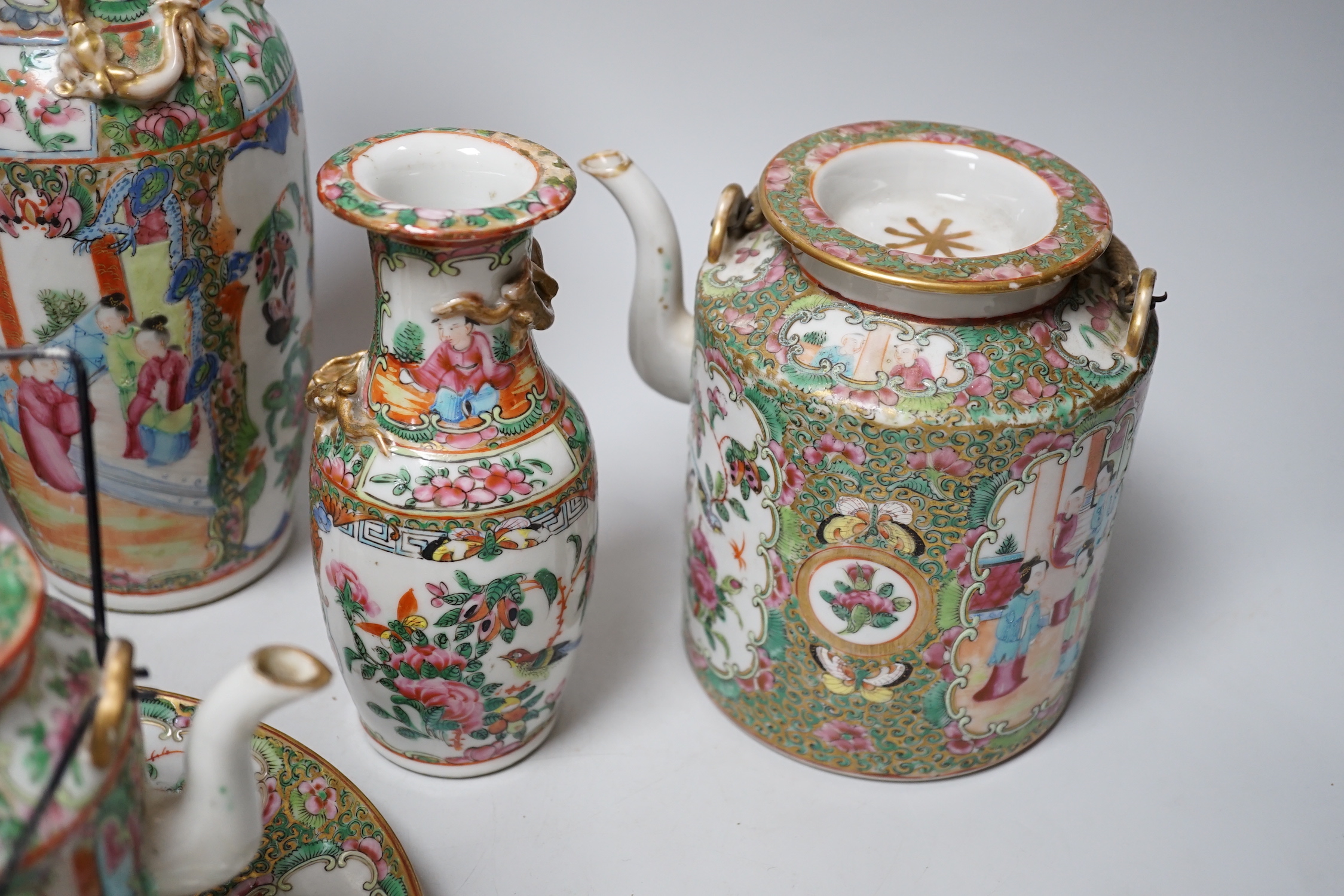 A collection of Chinese Cantonese famille rose vases, two teapots and a plate